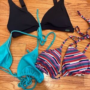 Three bathing suit tops. Roxy size xs, billabong size xs, and volcome size s